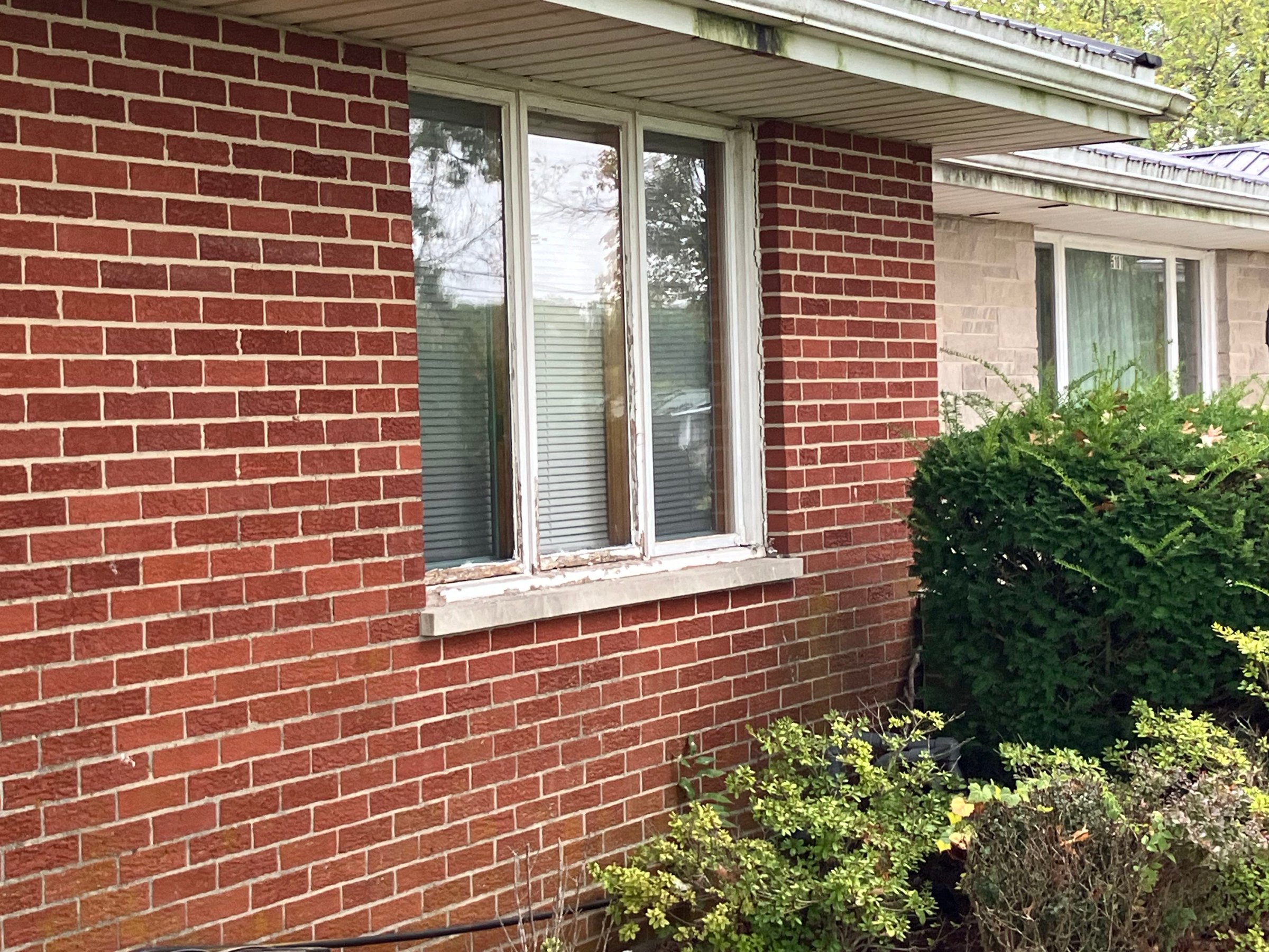 Weathered three-panel window before replacement