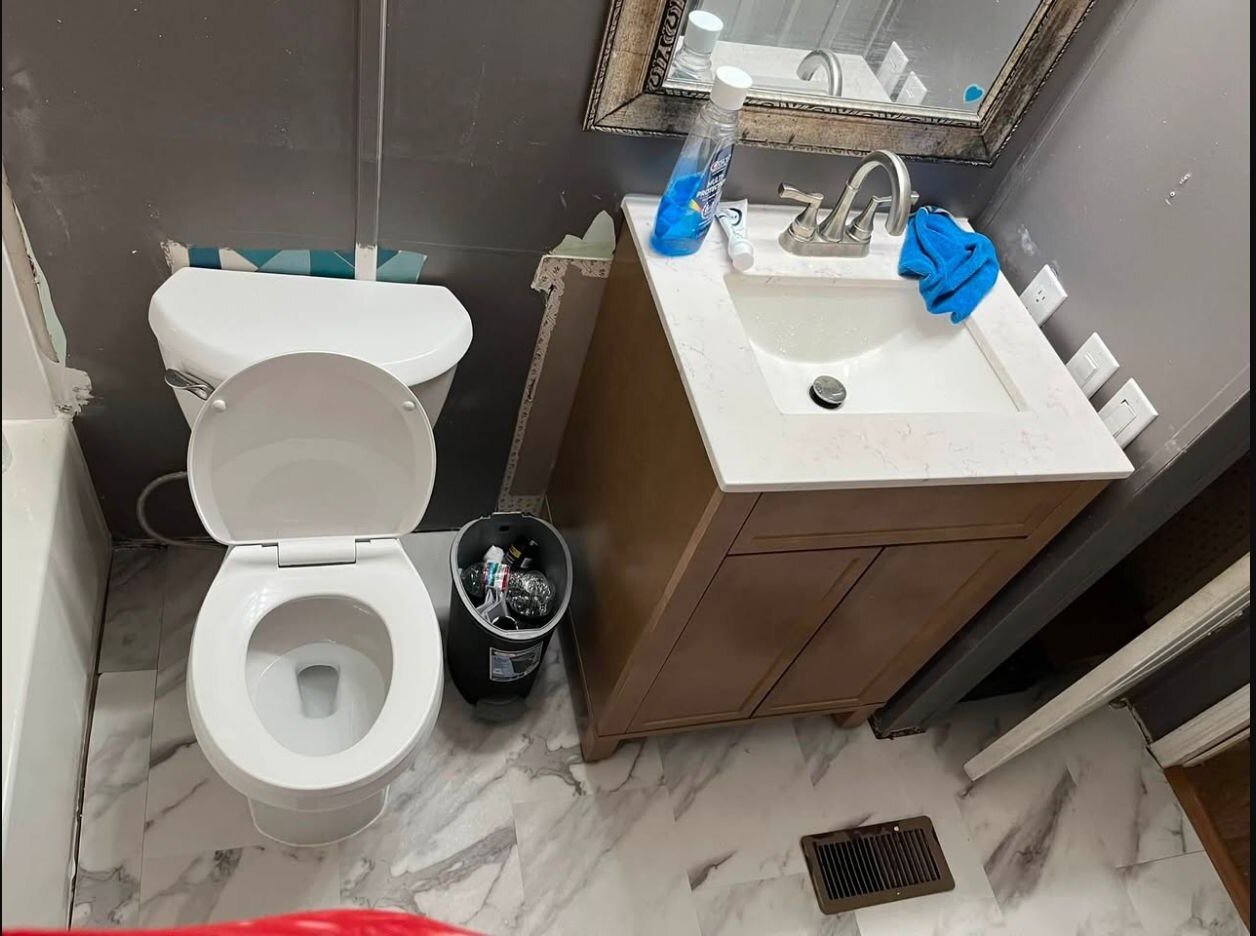 Installed bathroom vanity, sink, toilet and finished flooring