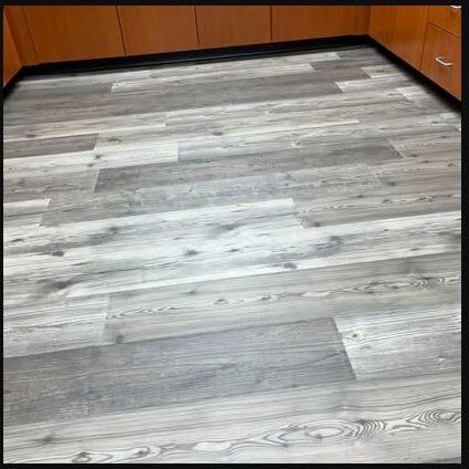 Finished gray plank flooring in a residential room