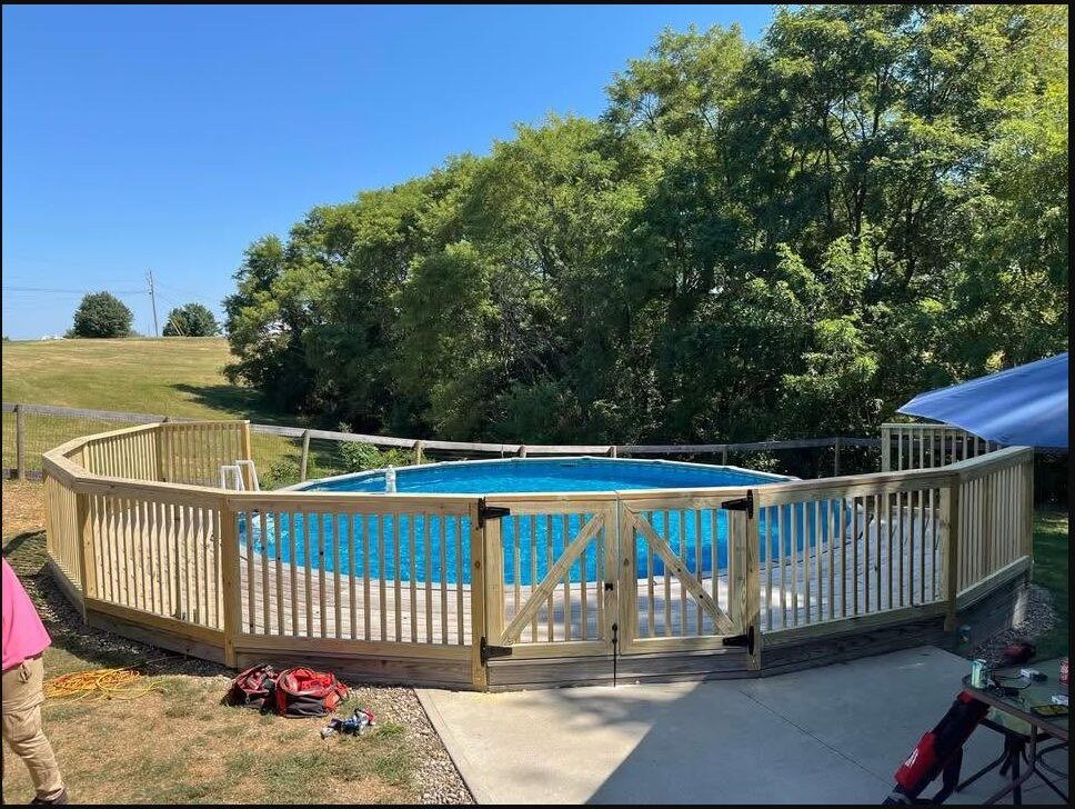 Finished pool deck with wood railing and dual gate