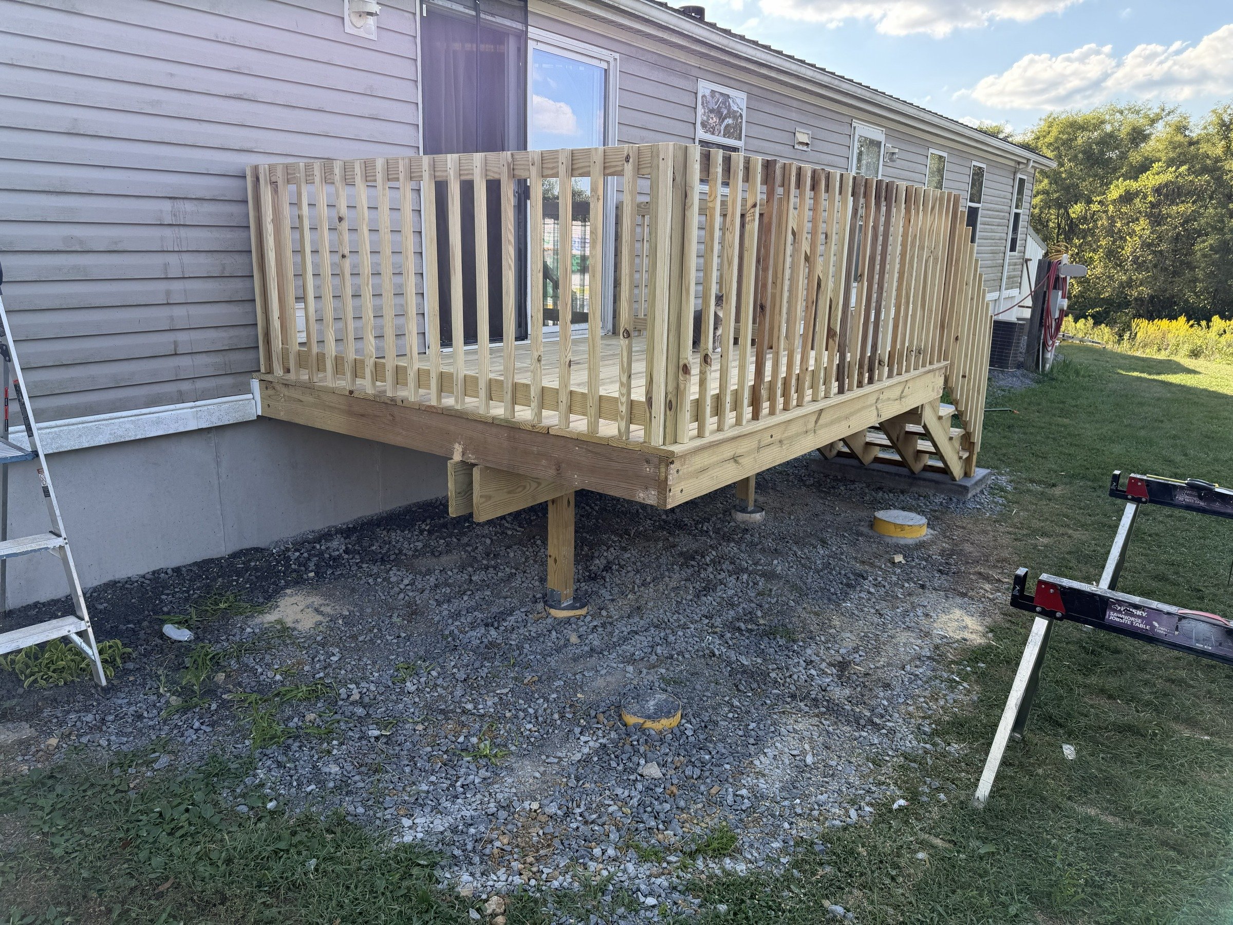 Entry deck with decking and balusters installed, before the top handrail