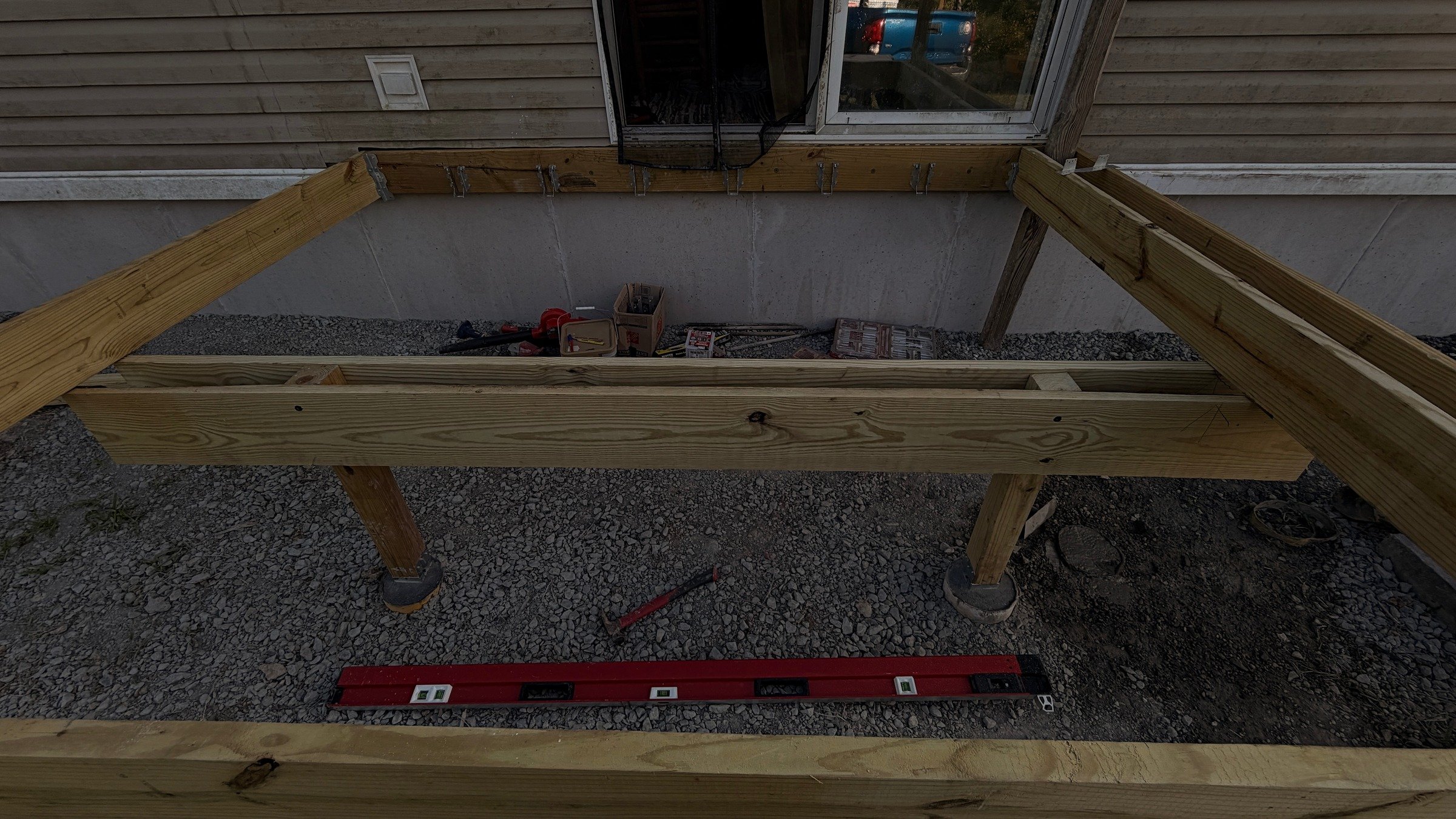 Open timber joists and crossmembers viewed across the entry-platform frame