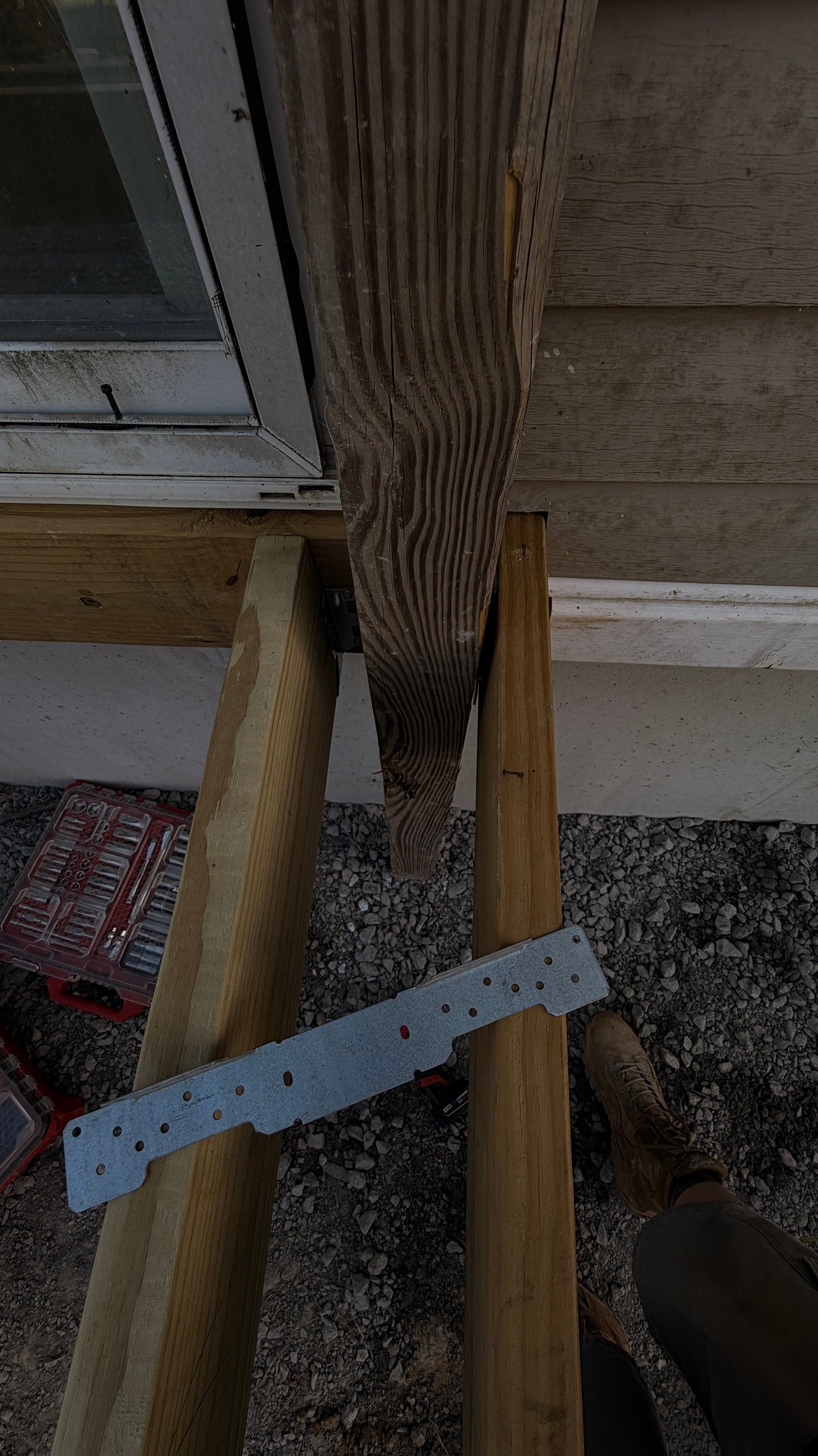 Close view of a timber post and adjoining members in the entry-platform frame