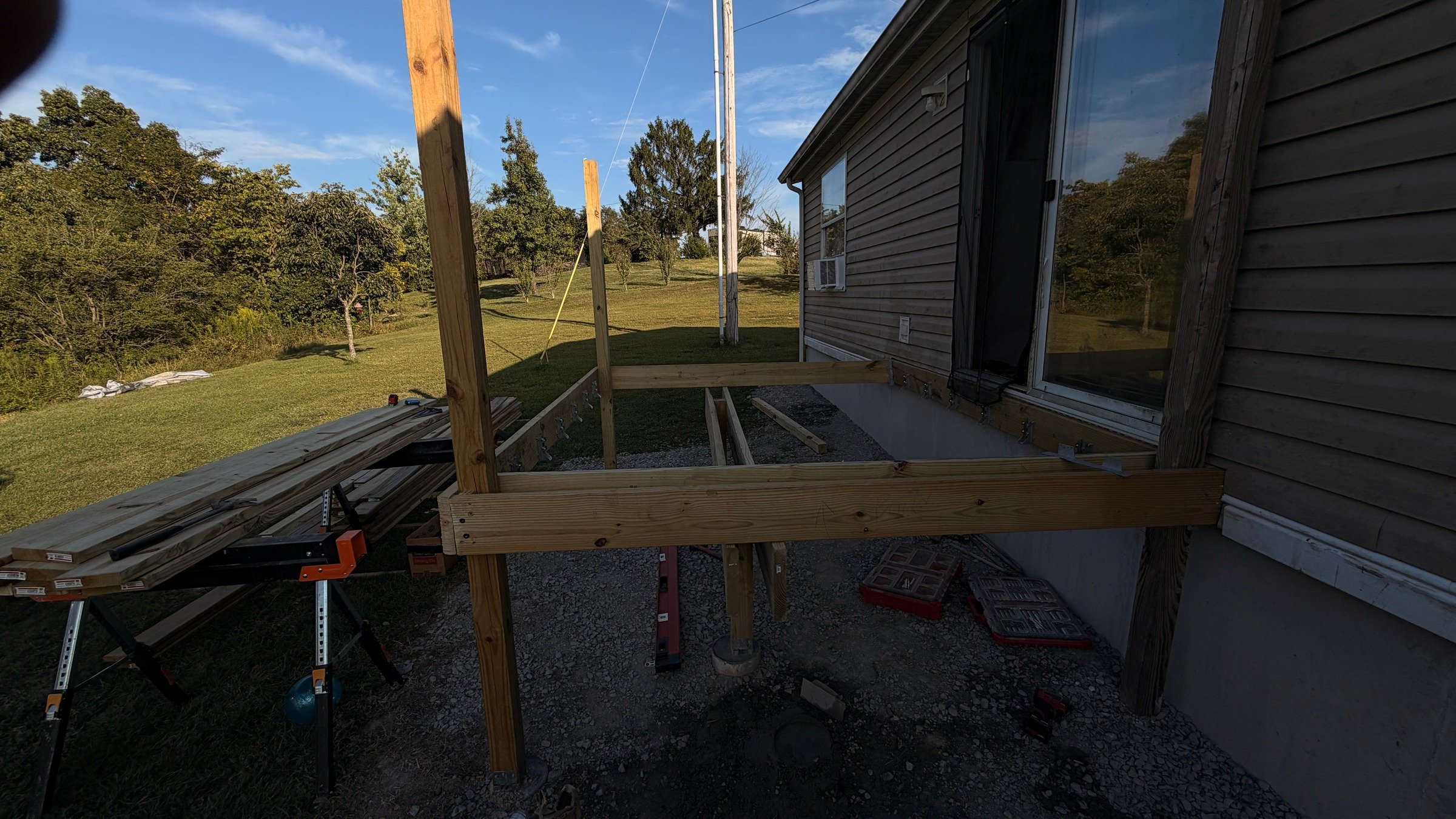 Side view of the timber entry-platform frame beside a sliding door