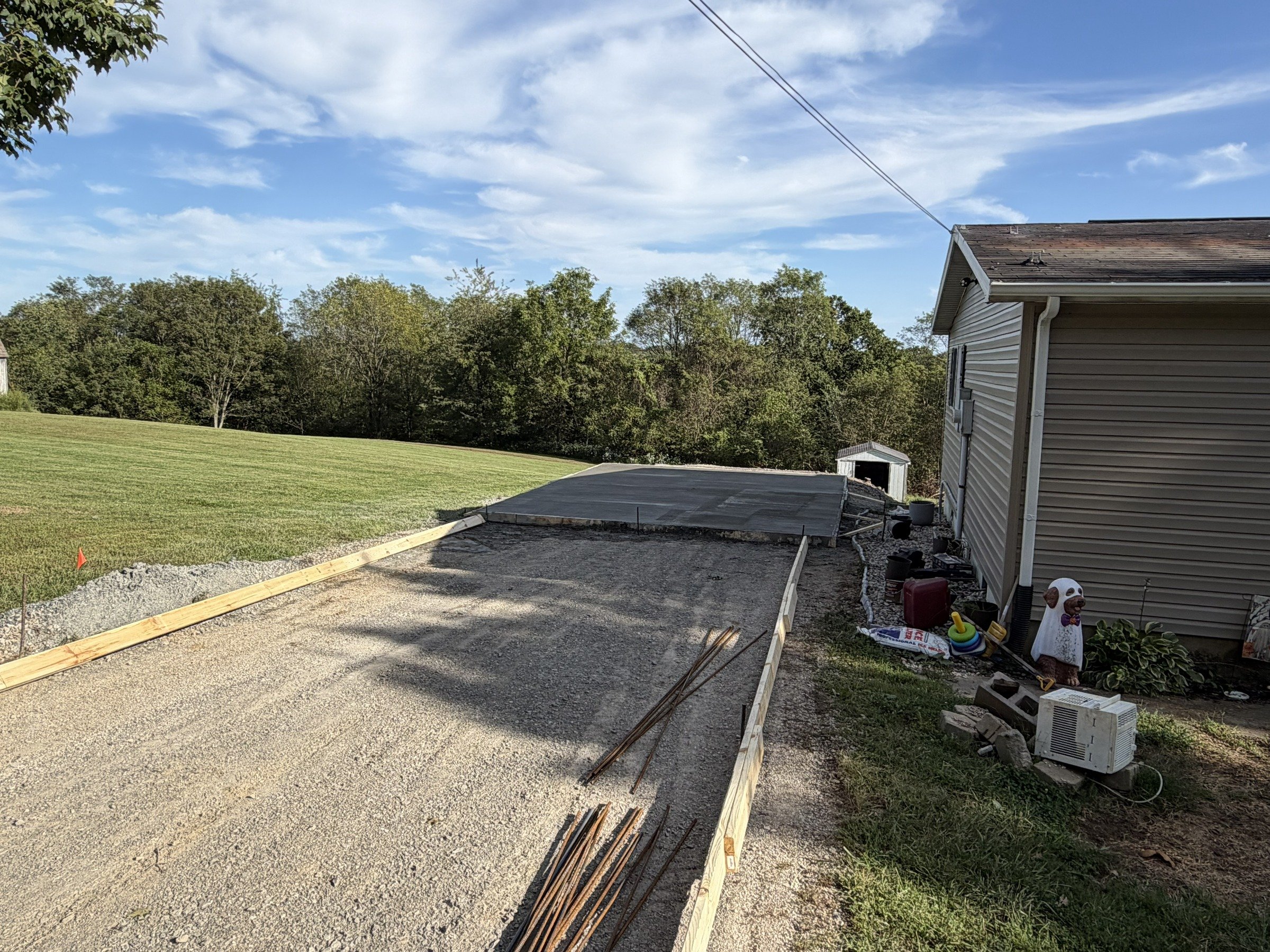 Timber forms and gravel beside a poured concrete section